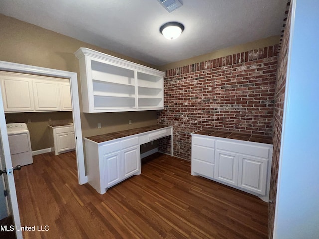 kitchen featuring white cabinetry, tile counters, dark hardwood / wood-style floors, and washer / dryer