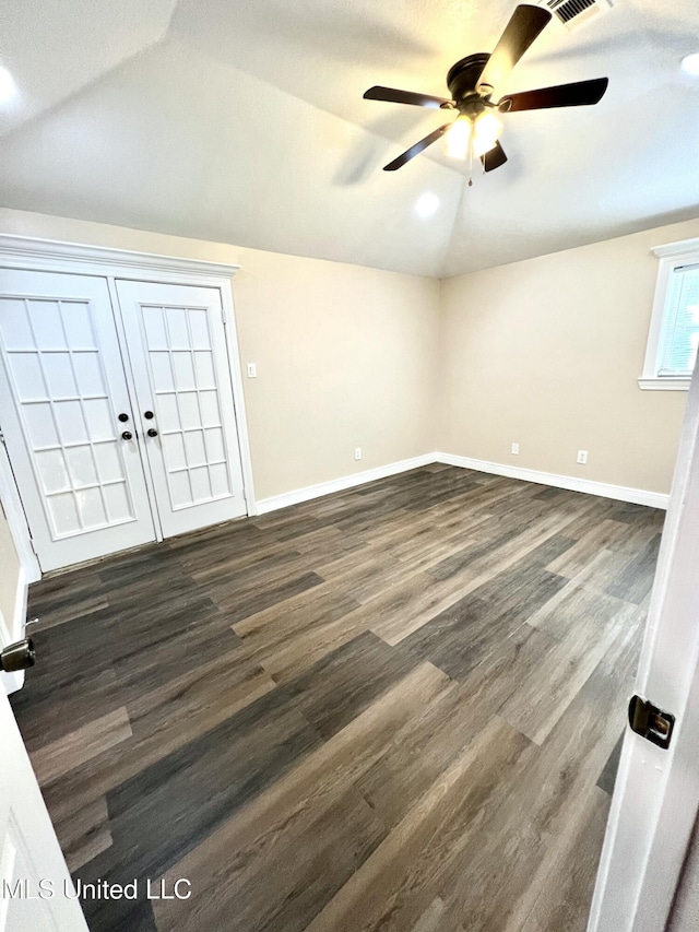 interior space featuring dark hardwood / wood-style floors, vaulted ceiling, and ceiling fan