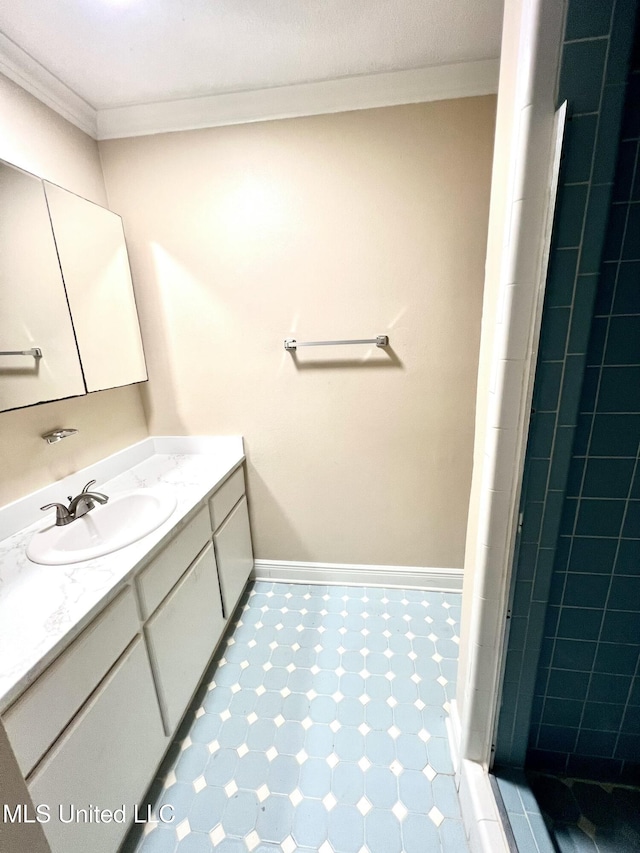 bathroom with a shower, vanity, and crown molding