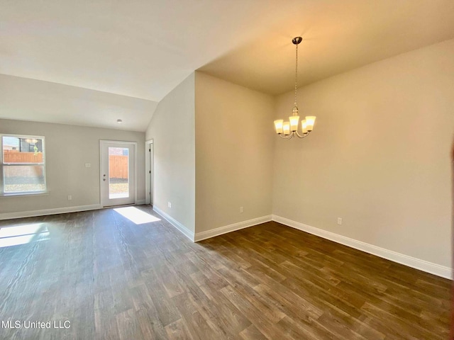 unfurnished room featuring dark wood-type flooring, vaulted ceiling, and a notable chandelier