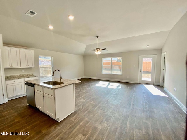 kitchen featuring sink, dishwasher, a kitchen island with sink, white cabinets, and vaulted ceiling