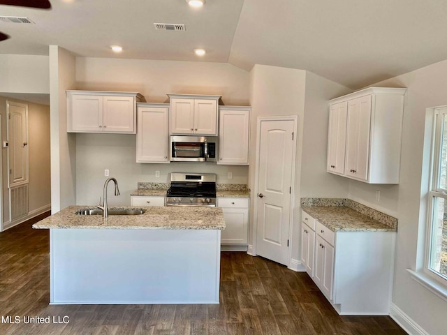 kitchen with white cabinetry, sink, stainless steel appliances, and a center island with sink