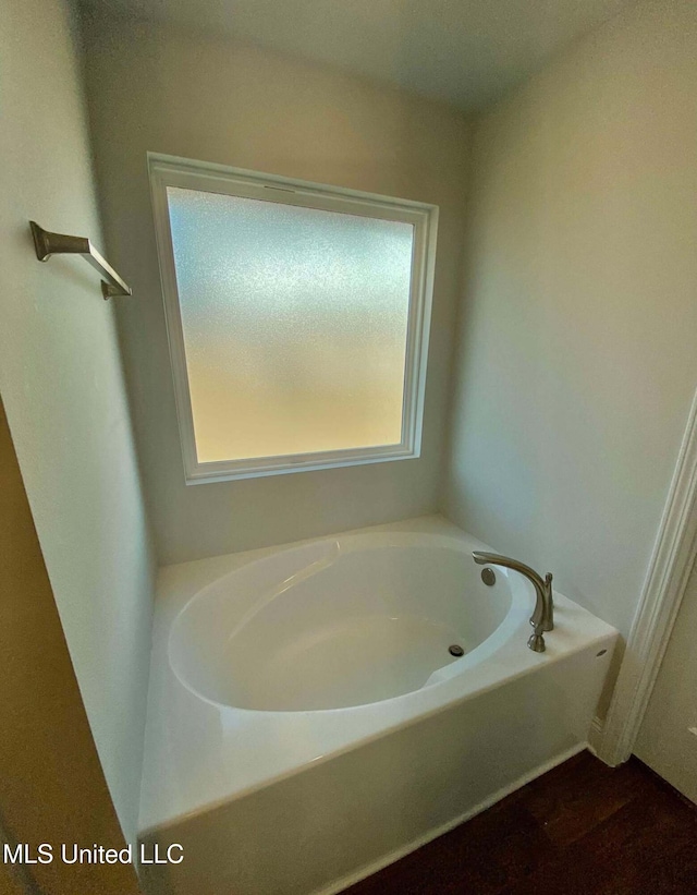 bathroom with a tub to relax in