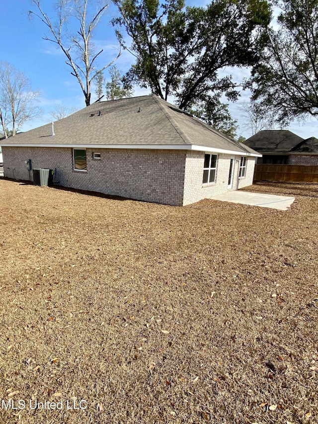 rear view of property with central air condition unit and a patio area