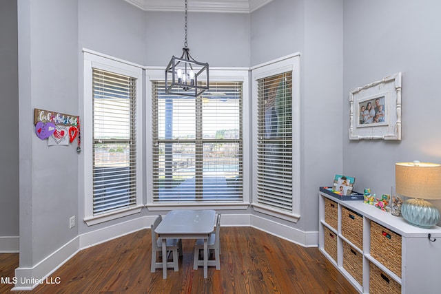 dining area featuring a notable chandelier, baseboards, a wealth of natural light, and wood finished floors