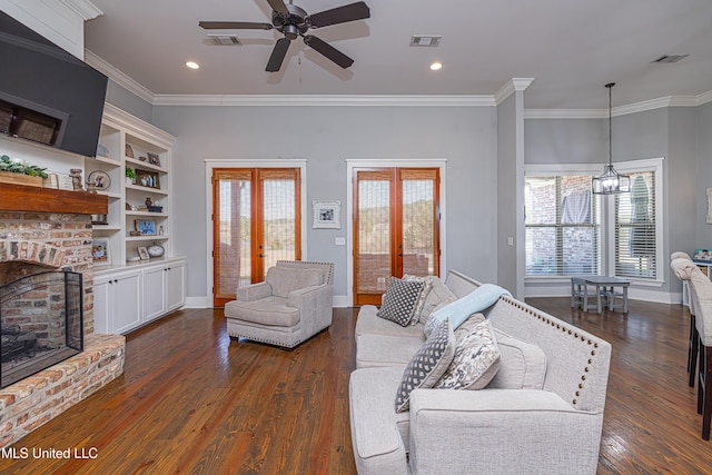 living area with a brick fireplace, french doors, and visible vents