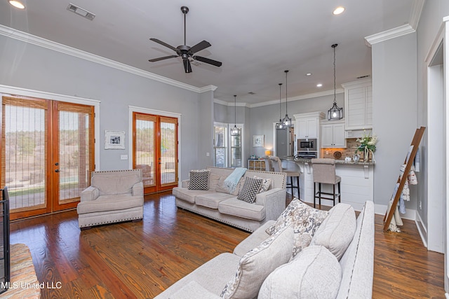 living room with ornamental molding, french doors, visible vents, and dark wood finished floors