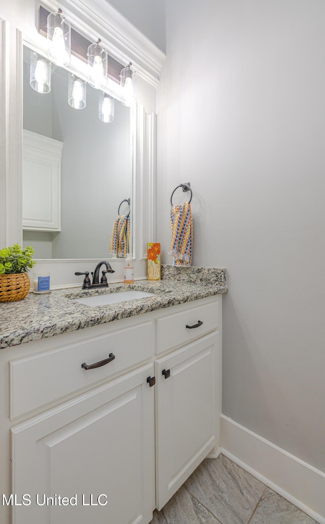 bathroom featuring vanity and baseboards