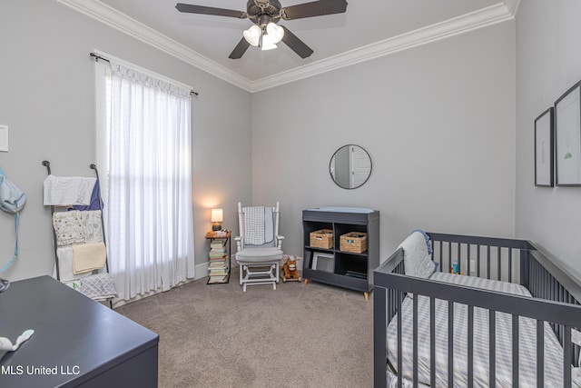 bedroom with carpet floors, a nursery area, ornamental molding, and a ceiling fan