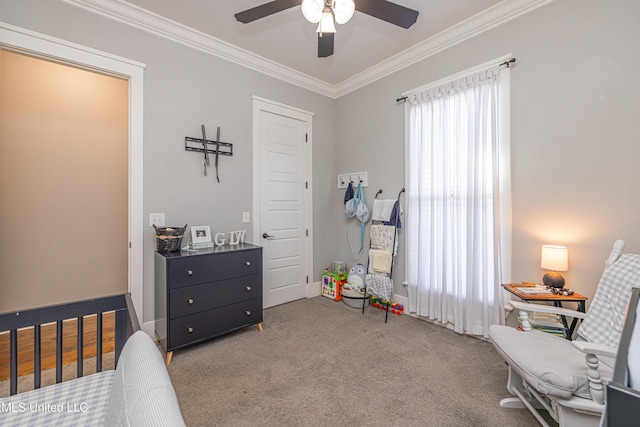 carpeted bedroom with a ceiling fan, crown molding, and baseboards