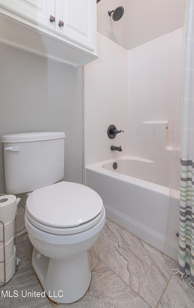 bathroom with shower / bathtub combination with curtain and toilet