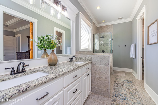 bathroom with ornamental molding, a stall shower, visible vents, and a sink