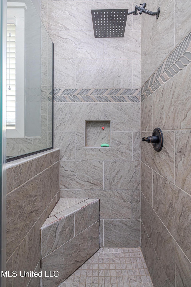 full bath with a tile shower