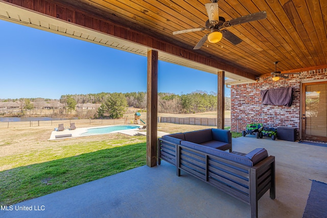 view of patio / terrace with a fenced in pool, a fenced backyard, an outdoor living space, and a ceiling fan