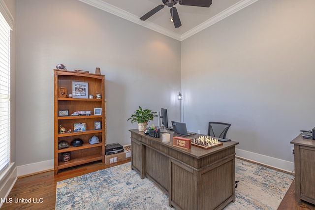 office with a ceiling fan, baseboards, crown molding, and light wood finished floors