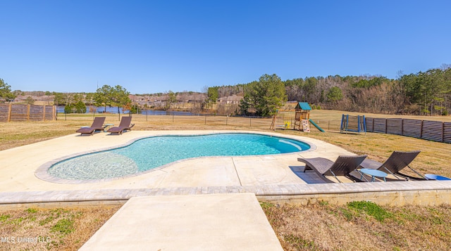 view of pool with a fenced in pool, a lawn, a patio, fence, and a playground