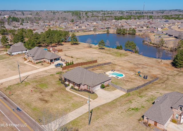 birds eye view of property with a water view and a residential view