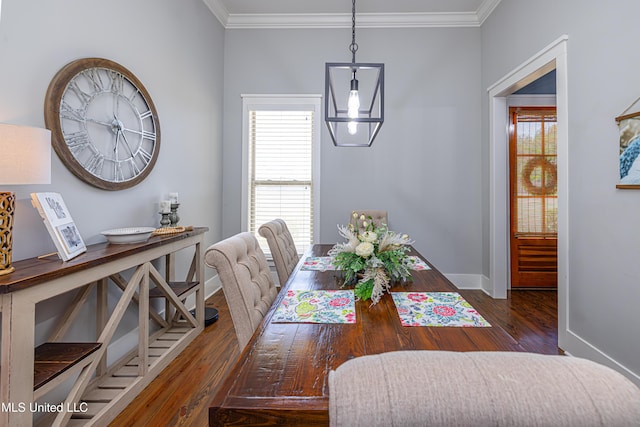 dining area featuring baseboards, ornamental molding, and wood finished floors