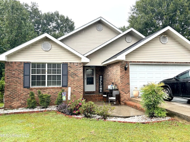 view of front of home featuring a garage and a front lawn