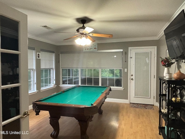 recreation room featuring wood finished floors, visible vents, and ornamental molding