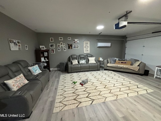 living room featuring wood finished floors, a garage, and a wall mounted AC