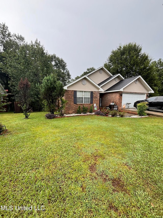 view of front of home with brick siding, a garage, and a front yard