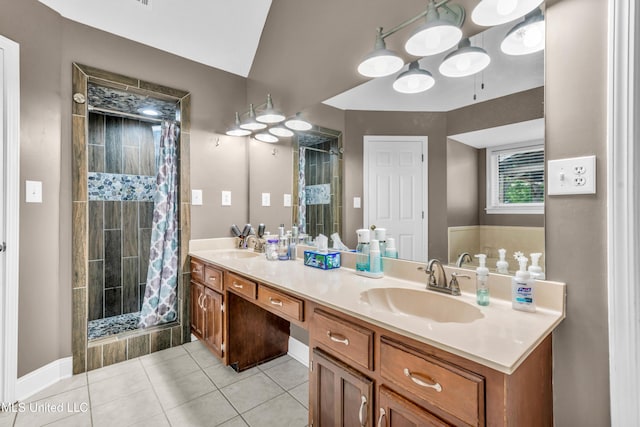 bathroom with a stall shower, tile patterned floors, double vanity, and baseboards