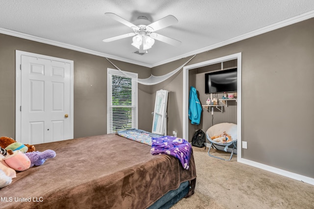 bedroom featuring carpet flooring, ornamental molding, a textured ceiling, a ceiling fan, and a closet
