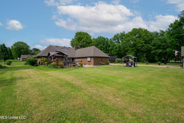 view of green lawn featuring a carport