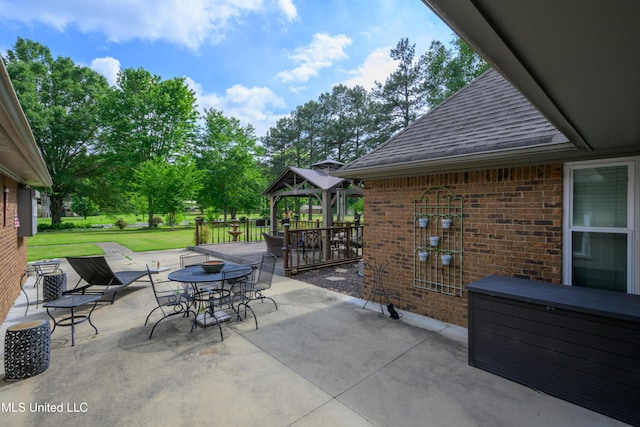 view of patio with a gazebo and outdoor dining space