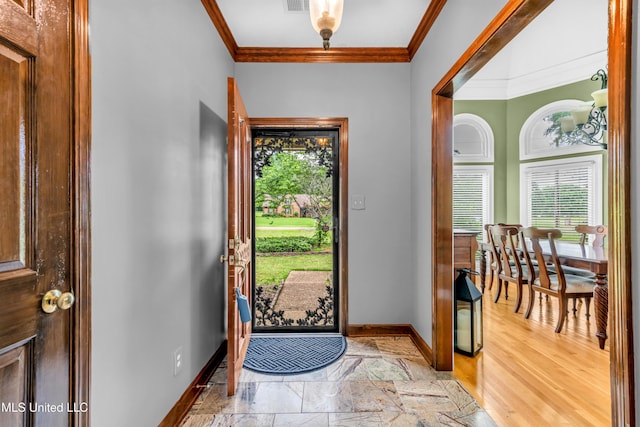 foyer entrance with baseboards and ornamental molding