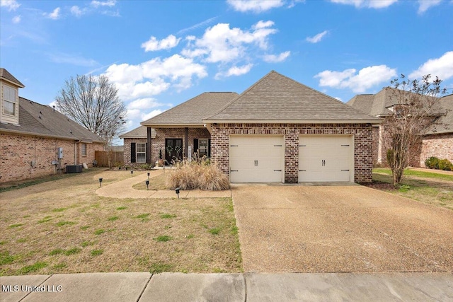 view of front of home with concrete driveway, roof with shingles, an attached garage, central air condition unit, and brick siding