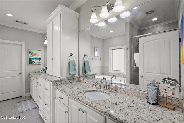 bathroom with vanity, a shower stall, visible vents, and crown molding