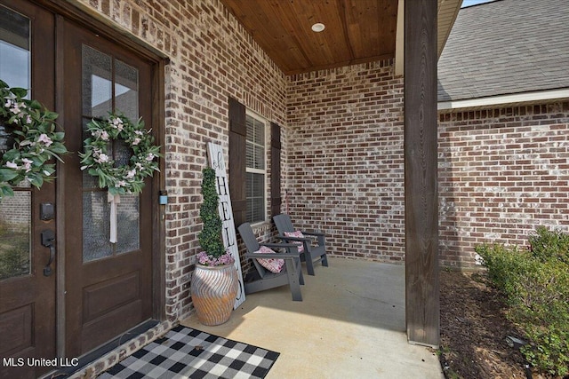 view of exterior entry featuring brick siding