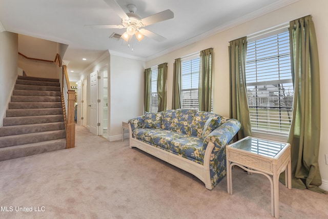 living room with baseboards, visible vents, light colored carpet, ornamental molding, and stairs