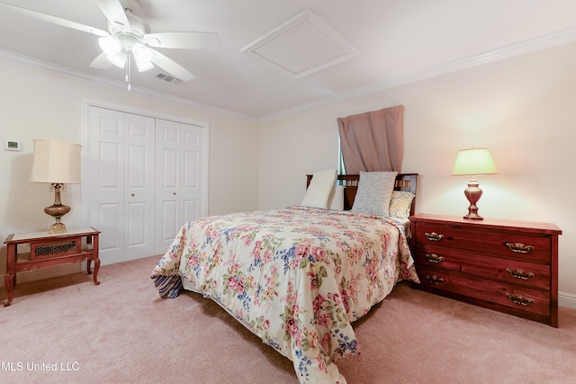 bedroom with attic access, visible vents, light colored carpet, crown molding, and a closet