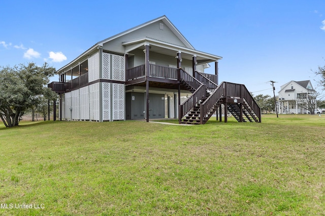 rear view of property with stairs and a yard