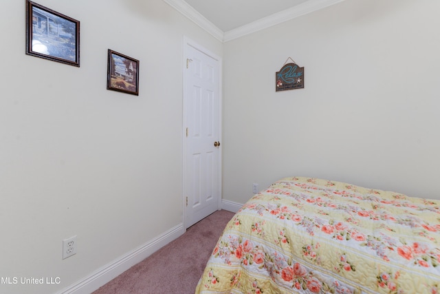 bedroom with ornamental molding, carpet flooring, and baseboards