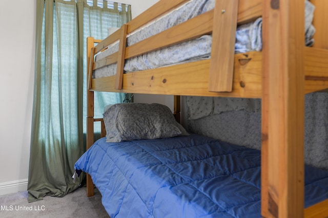 carpeted bedroom with baseboards