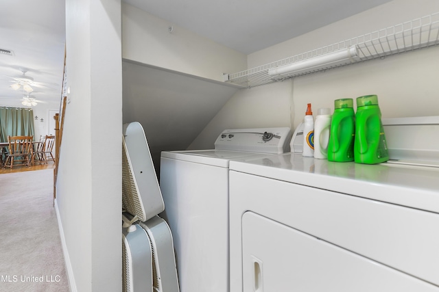 laundry area with light carpet, laundry area, visible vents, baseboards, and washer and clothes dryer