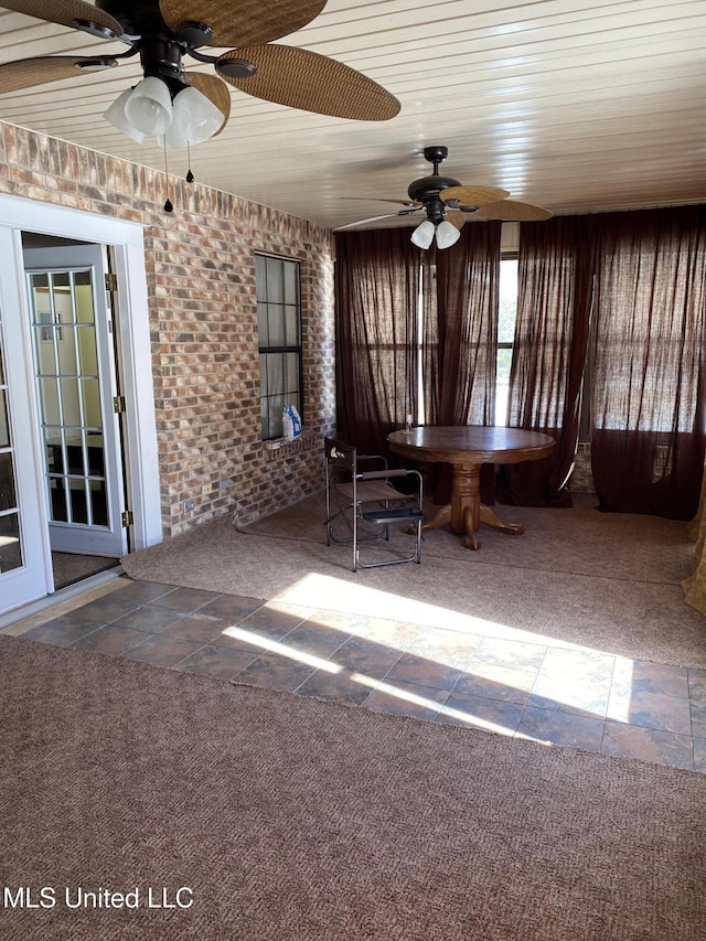 interior space with ceiling fan