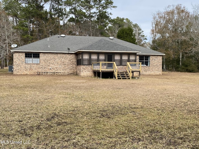 rear view of house with a wooden deck, central AC unit, and a lawn