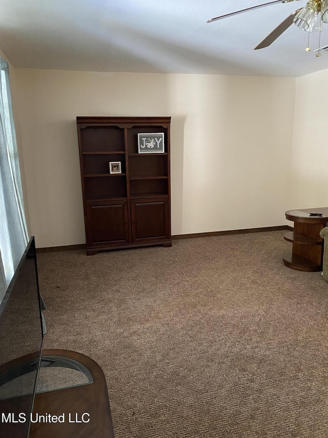 interior space with carpet flooring and ceiling fan