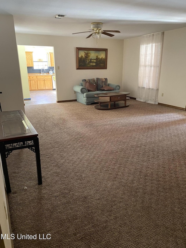 living room with carpet floors and ceiling fan