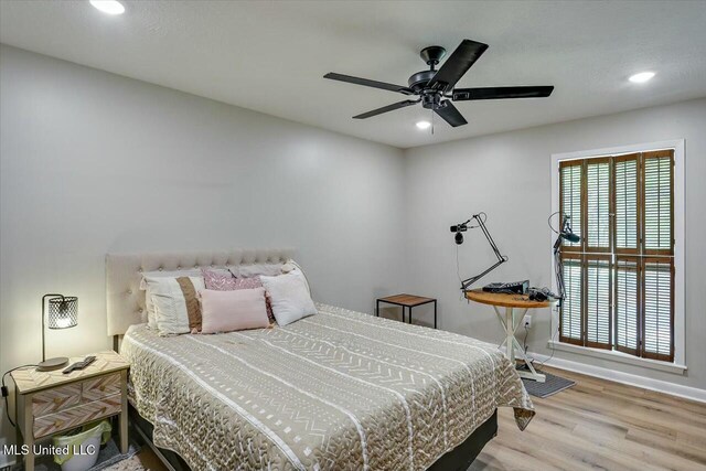 bedroom featuring recessed lighting, wood finished floors, and multiple windows