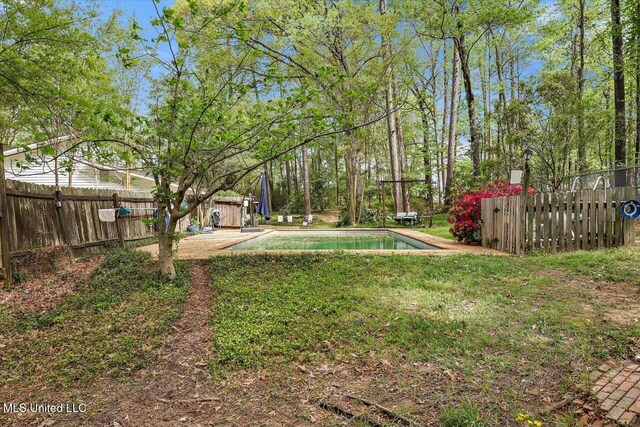 view of yard with fence and a fenced in pool