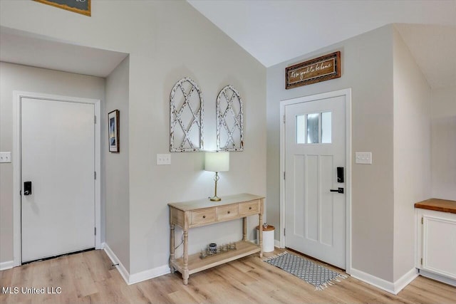 entrance foyer featuring light wood-style flooring and baseboards