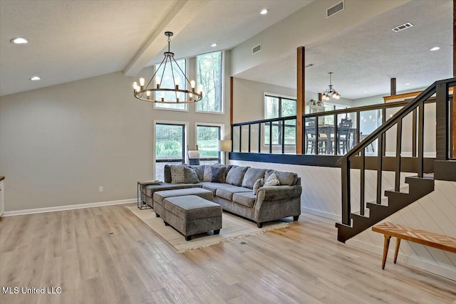 living area featuring visible vents, an inviting chandelier, and light wood finished floors