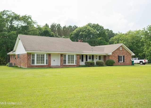 324 Bob White Dr, Canton, MS 39046 - ranch-style home with central air condition unit, a front lawn, brick siding, and a chimney