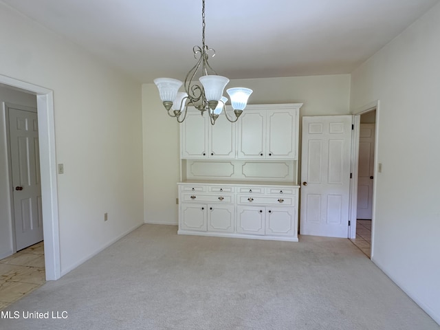 324 Bob White Dr, Canton, MS 39046 - unfurnished dining area featuring a chandelier, light colored carpet, and baseboards